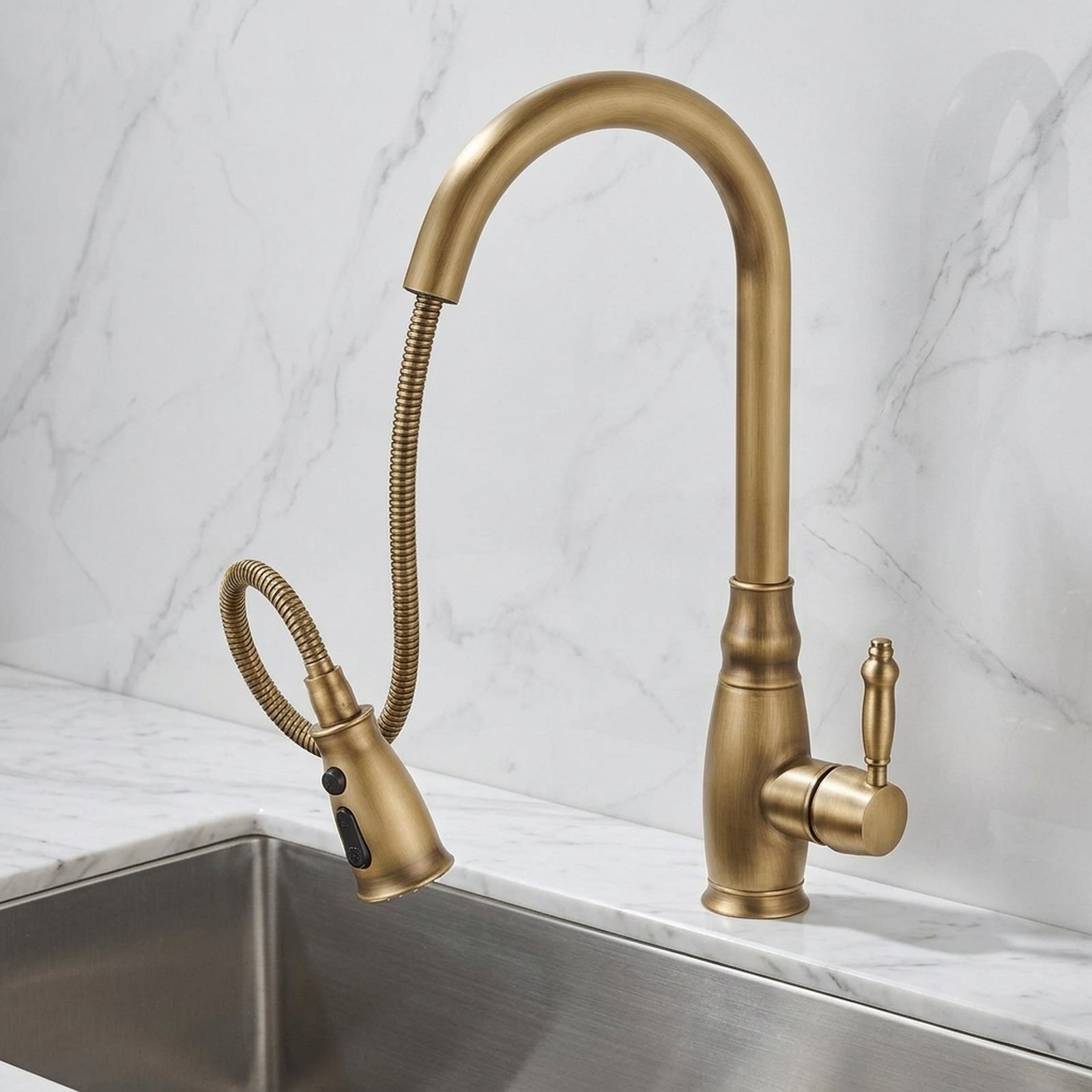 Antique brass kitchen faucet with water running on marble
